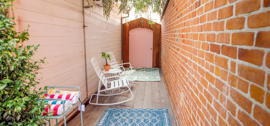 A Roberta Rocker set in white in an outdoor space