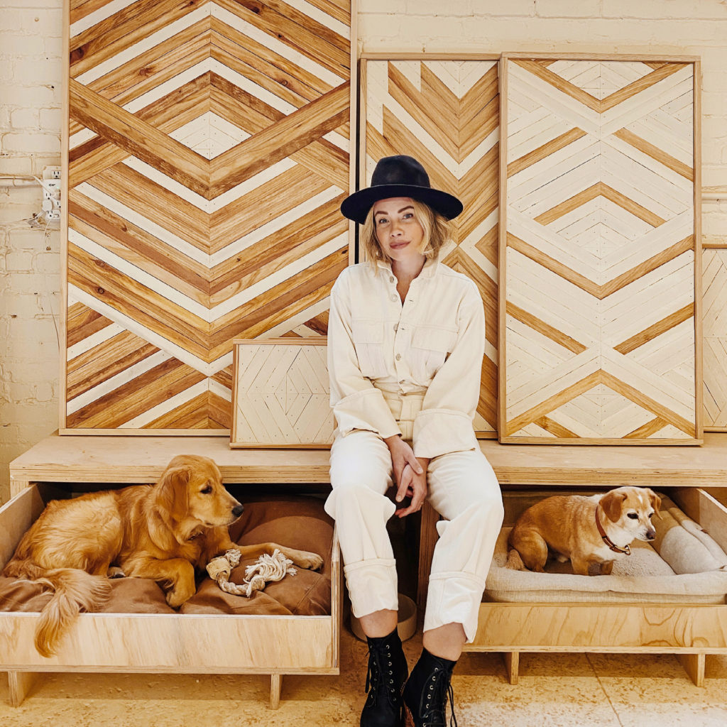 Zee with her two dogs in her Oakland studio and workshop