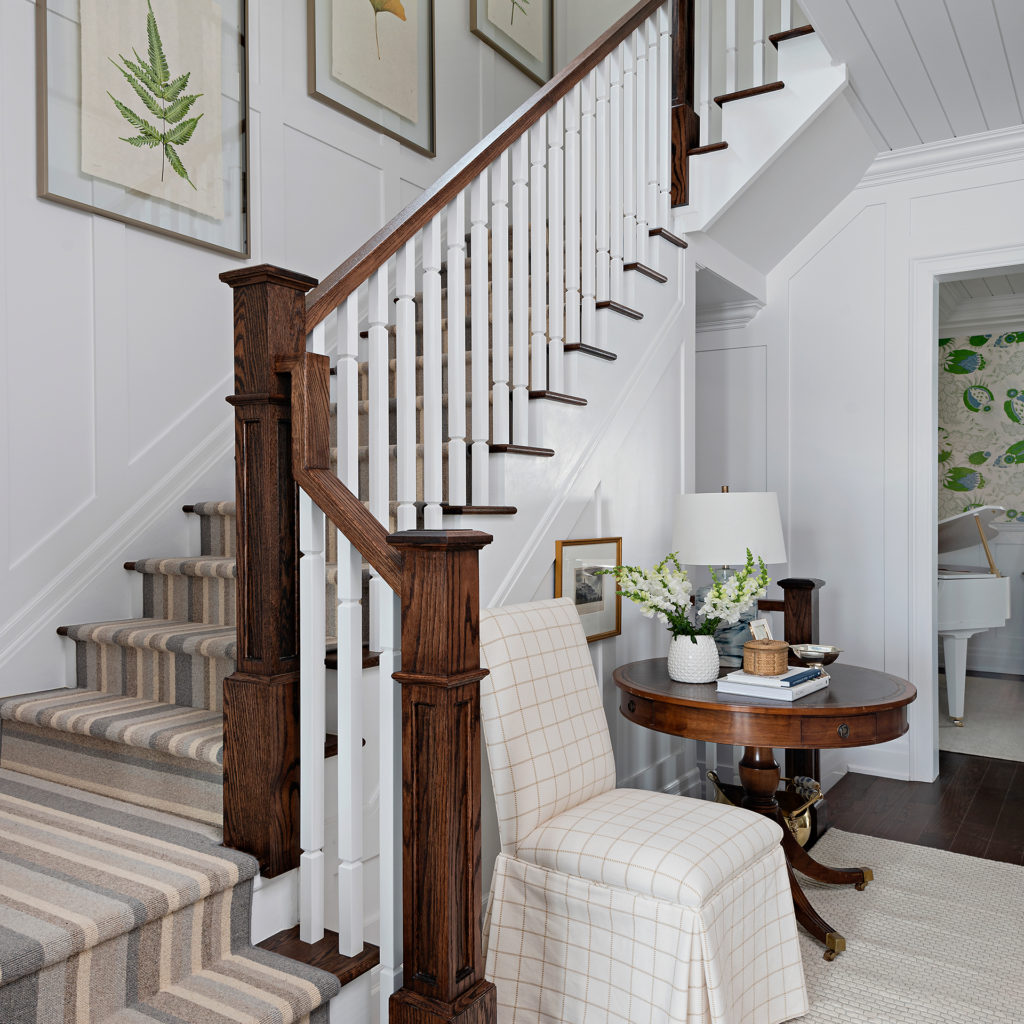 The staircase appointed with framed botanical prints