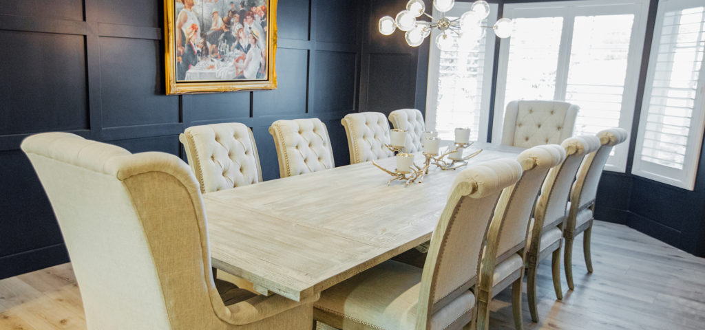 The dining room with a reclaimed dining table and tufted side chairs from RH