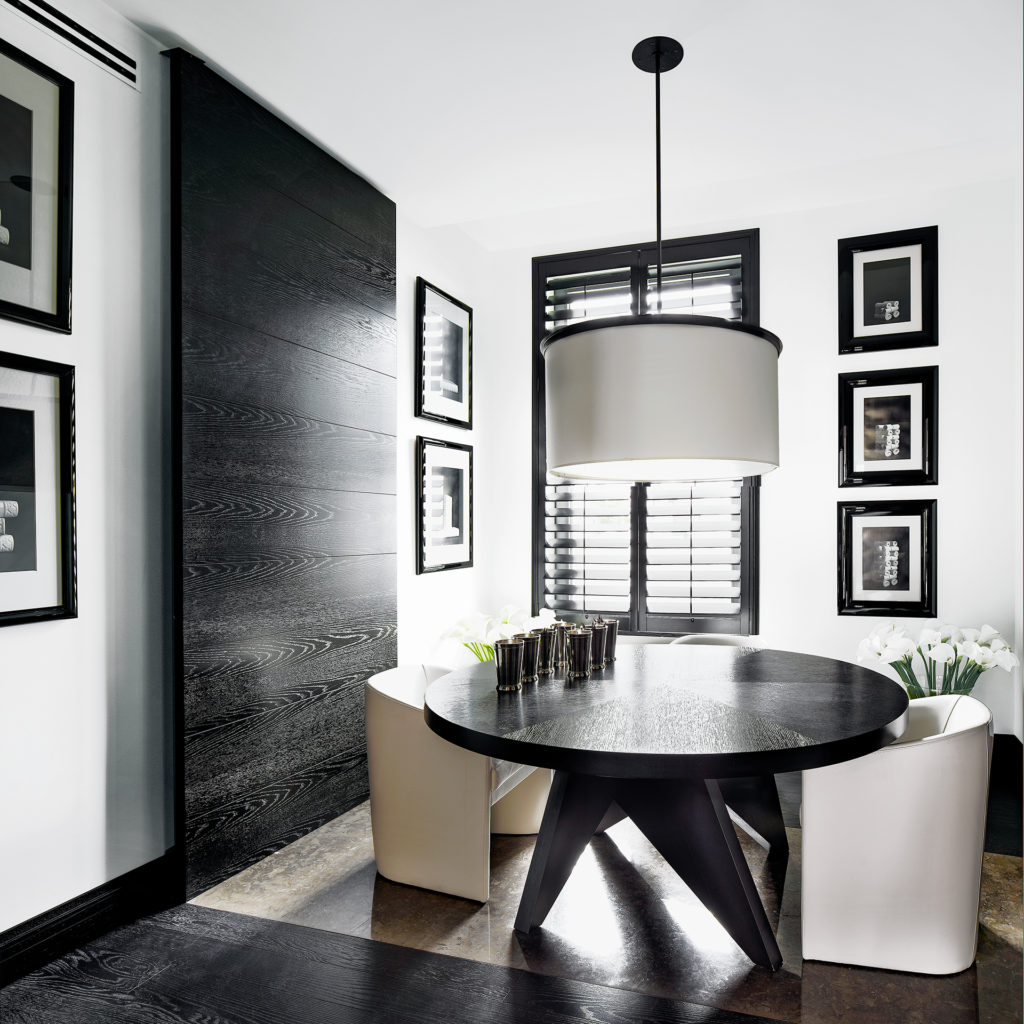 A dining room with high contrast designed by Kelly Hoppen