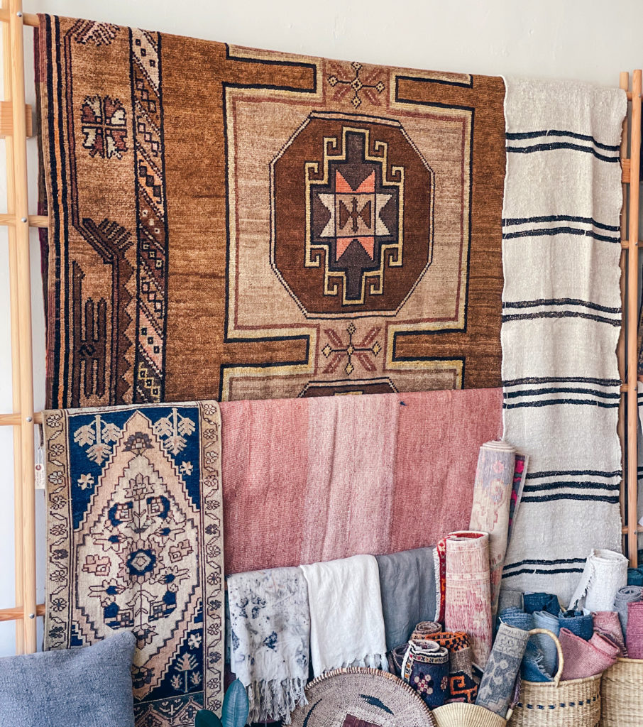 An assortment of rugs, throws, and baskets at Home