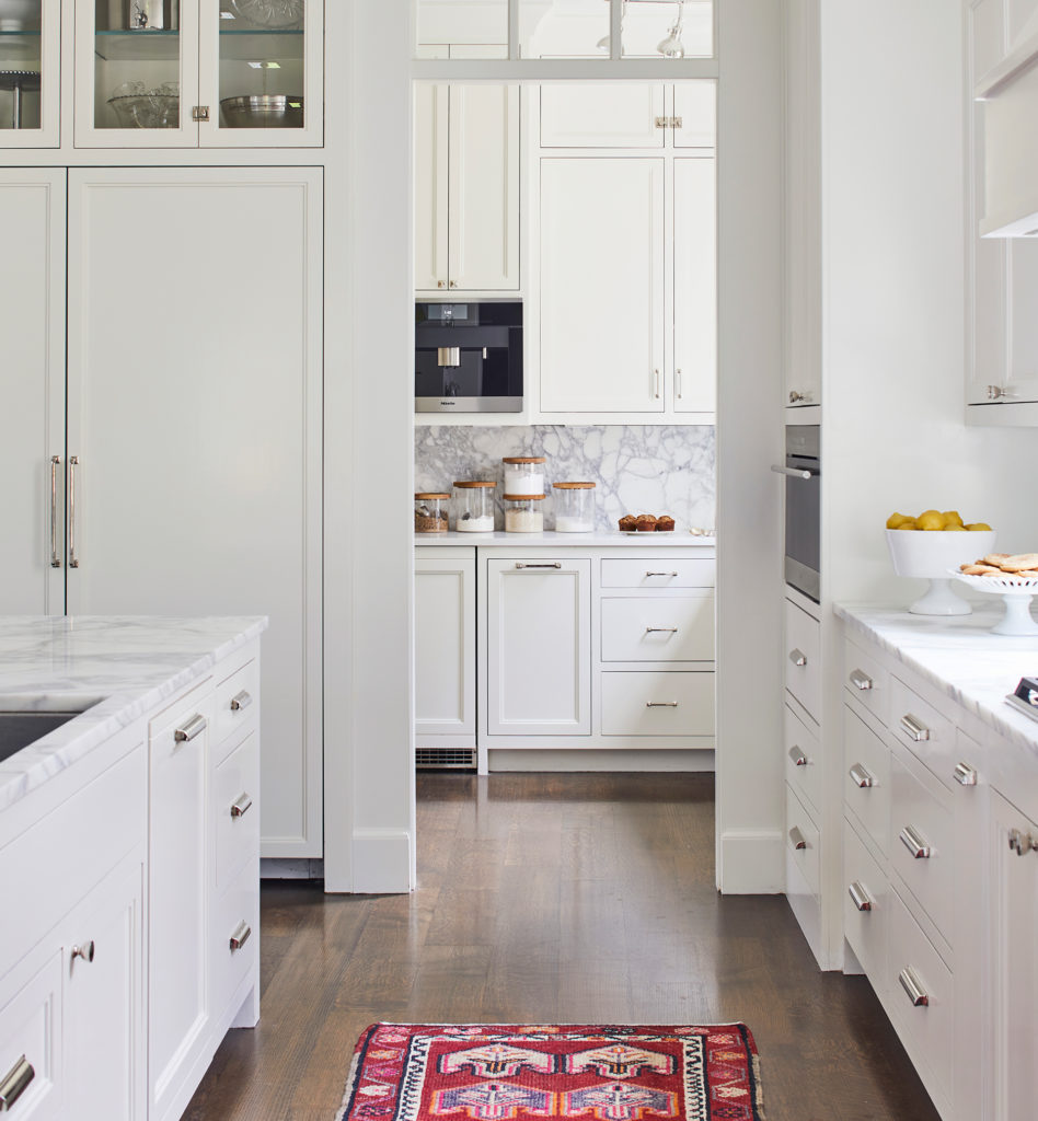 The all-white kitchen with a vintage runner