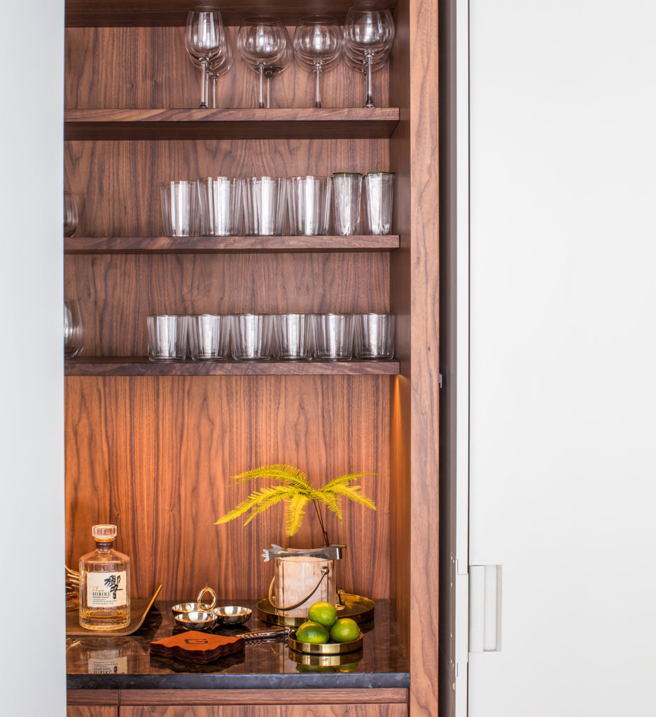 A custom walnut bookcase in a five-apartment building designed by Glickman Schlesinger Architects