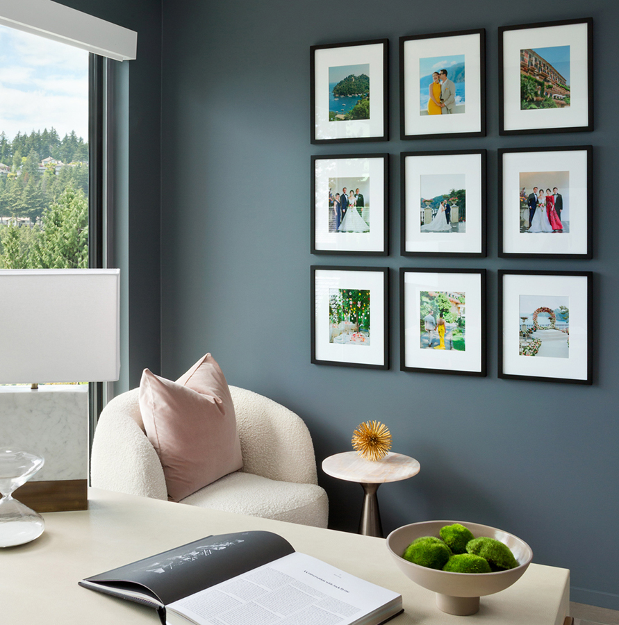 A home office with a wall of framed photographs