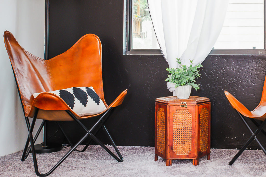 A seating area inside a casita with leather butterfly-style chairs