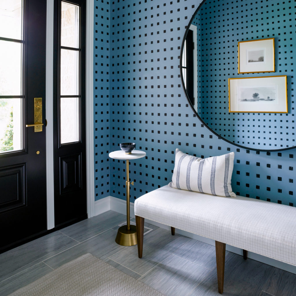 The foyer with a bold blue-and-black wallpaper
